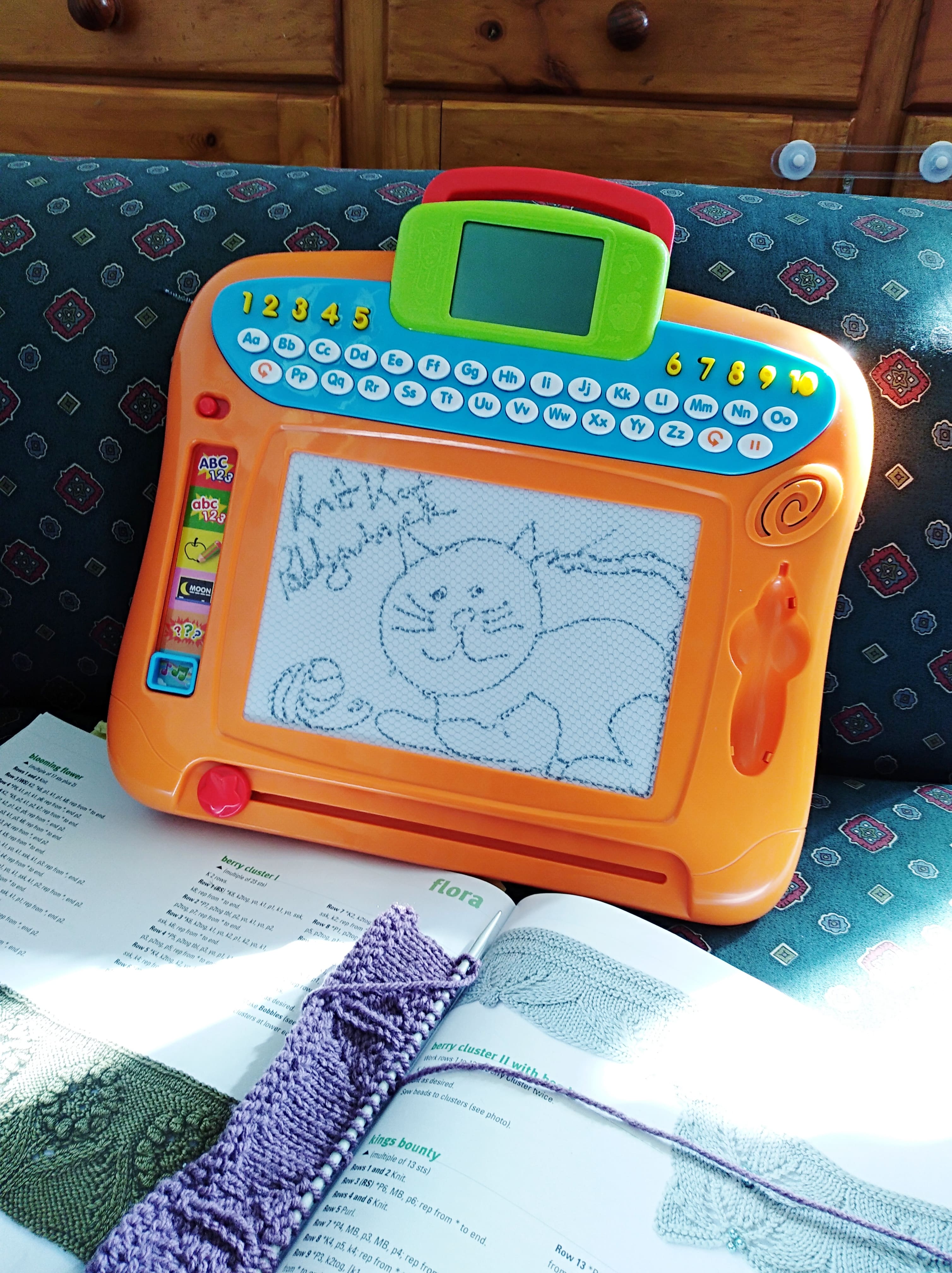 Child's magnetic drawing pad with blog name and logo drawn on it
