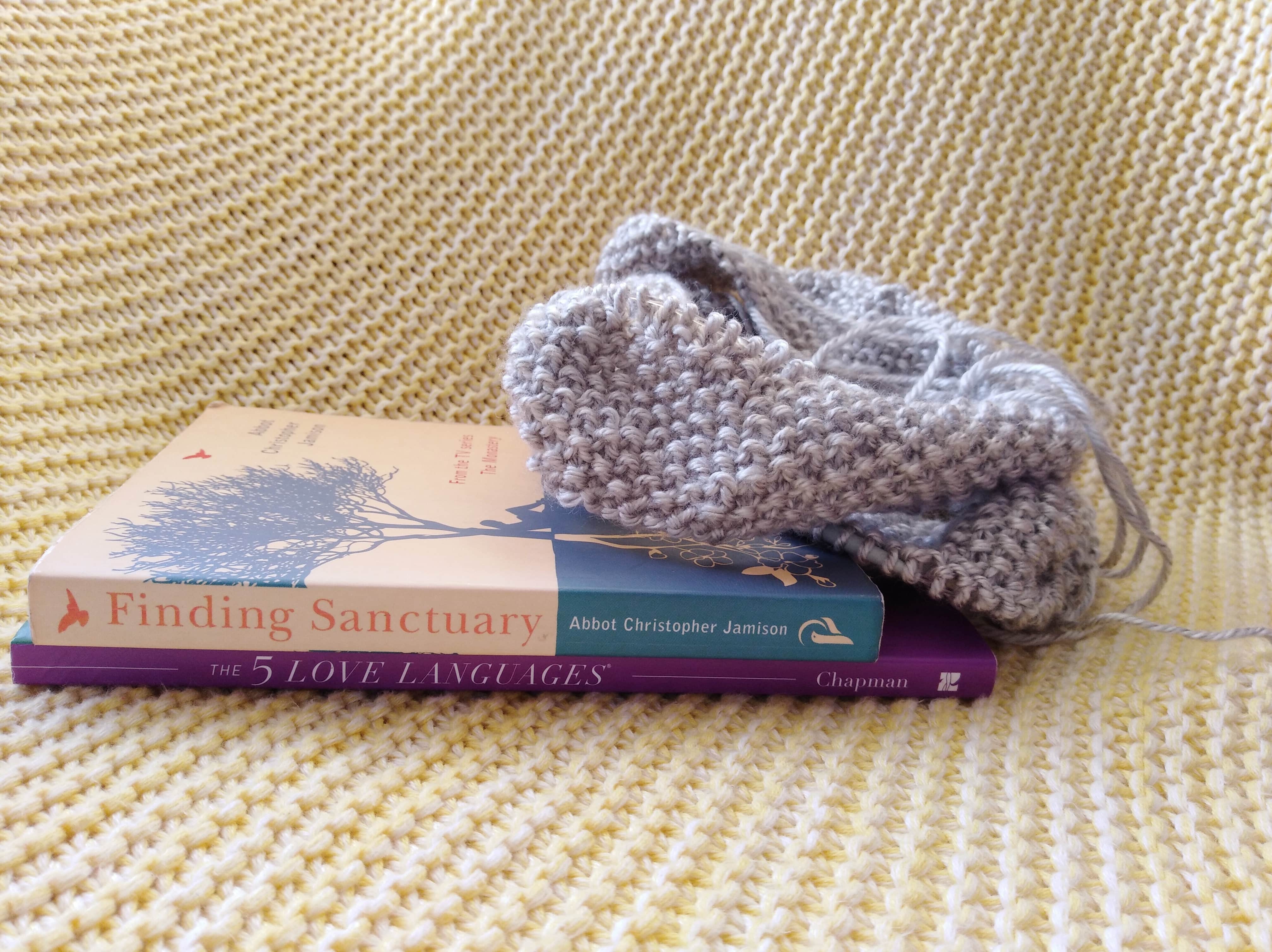 Image of knitting in progress and two books